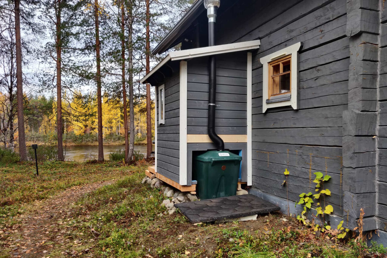 Huussi mökin kyljessä